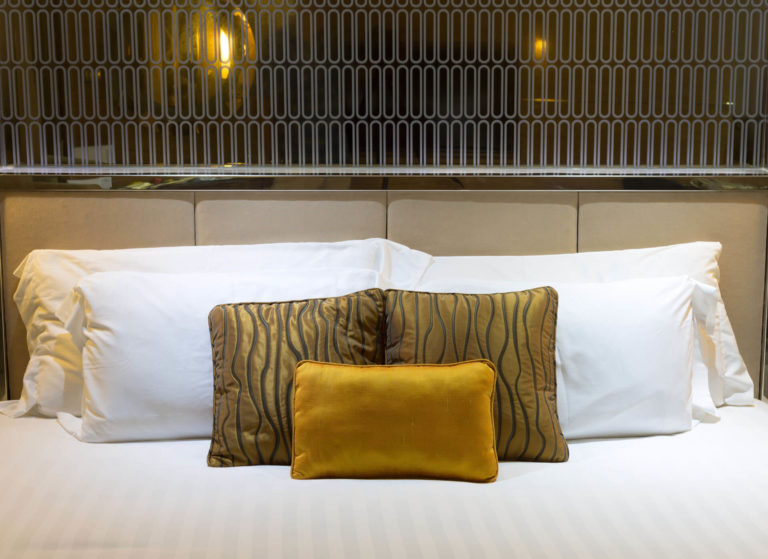 pillows-on-beds-in-hotel-PQKFXQN
